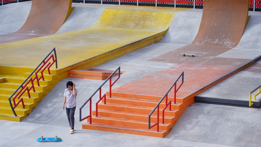 woman in white shirt and black pants standing on white concrete staircase