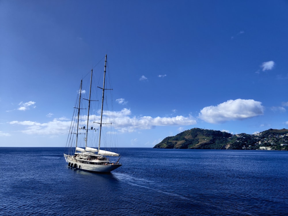 white boat on sea under blue sky during daytime