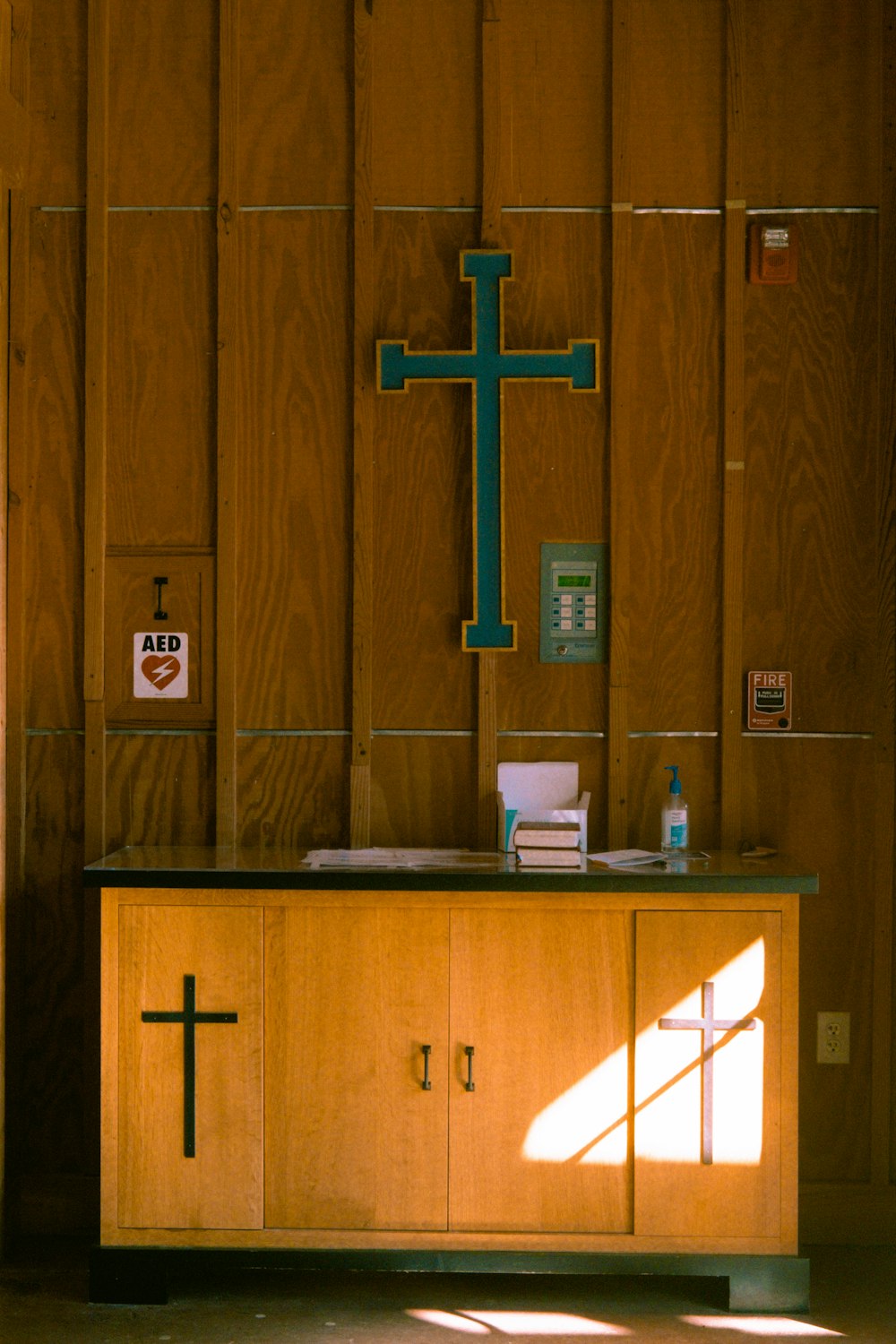 brown wooden cross on brown wooden wall