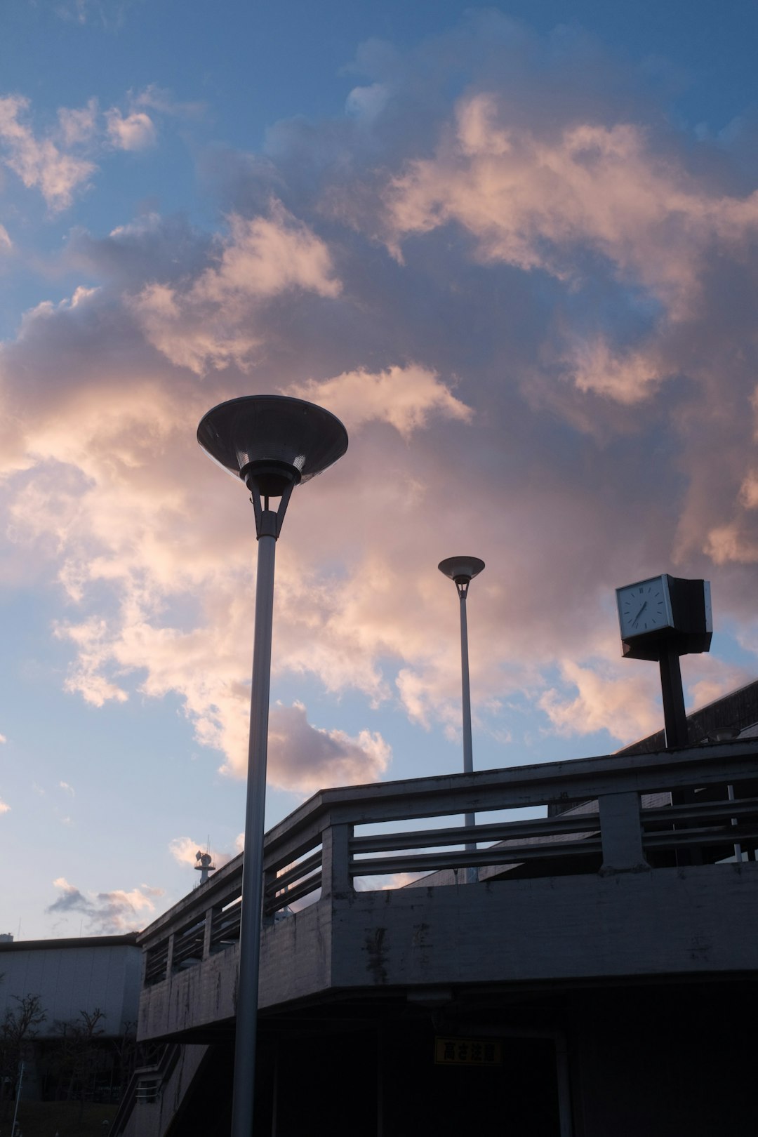 black street light under cloudy sky during daytime