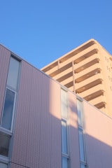 A modern residential building with Kuwait city skyline in the background.