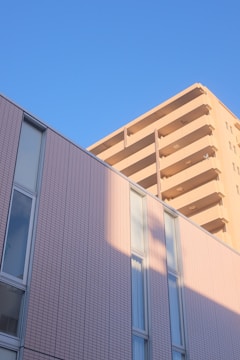A modern residential building with Kuwait city skyline in the background.