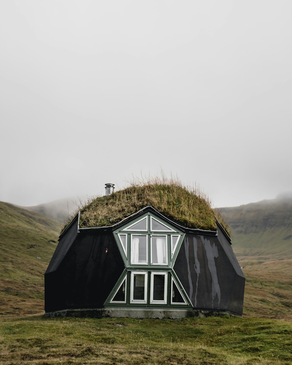 white and green wooden house on green grass field