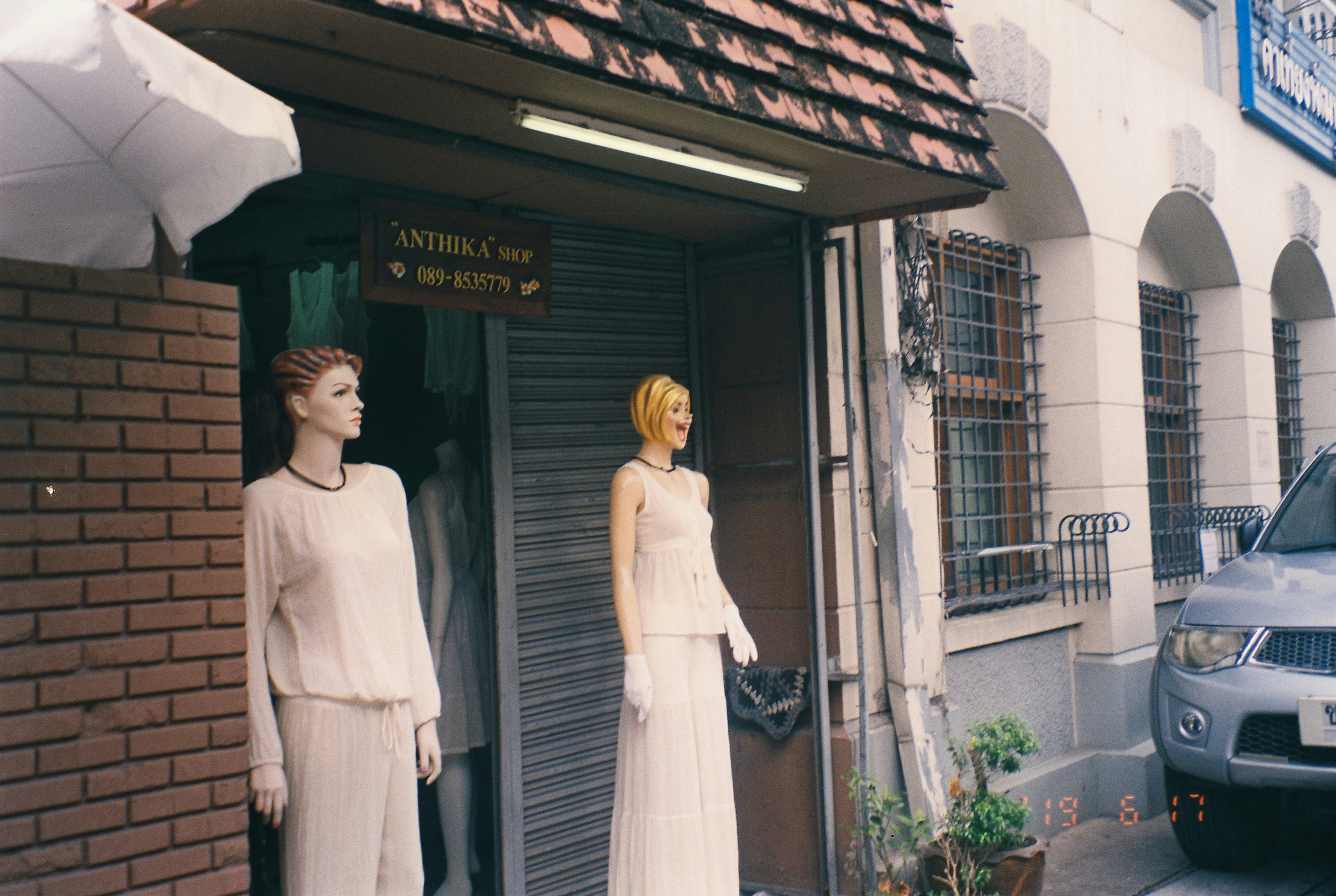 woman in white long sleeve dress standing near door