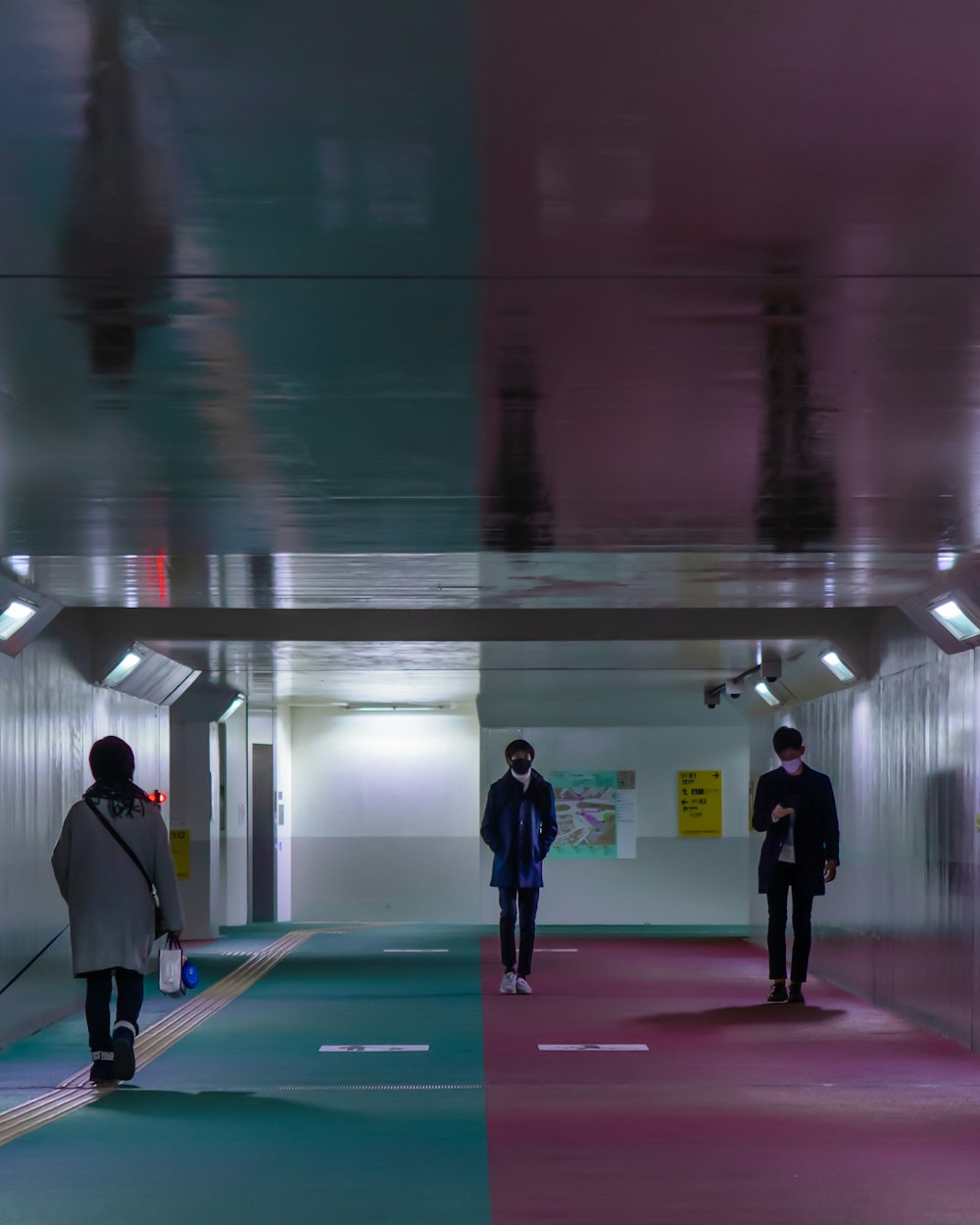 man in black jacket walking on red and white hallway