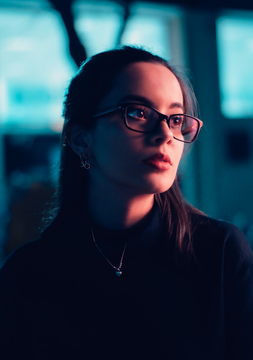 woman in black framed eyeglasses and black crew neck shirt