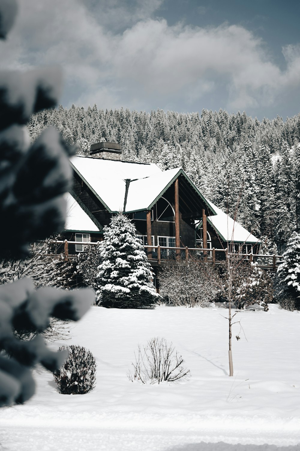 brown wooden house covered with snow during daytime