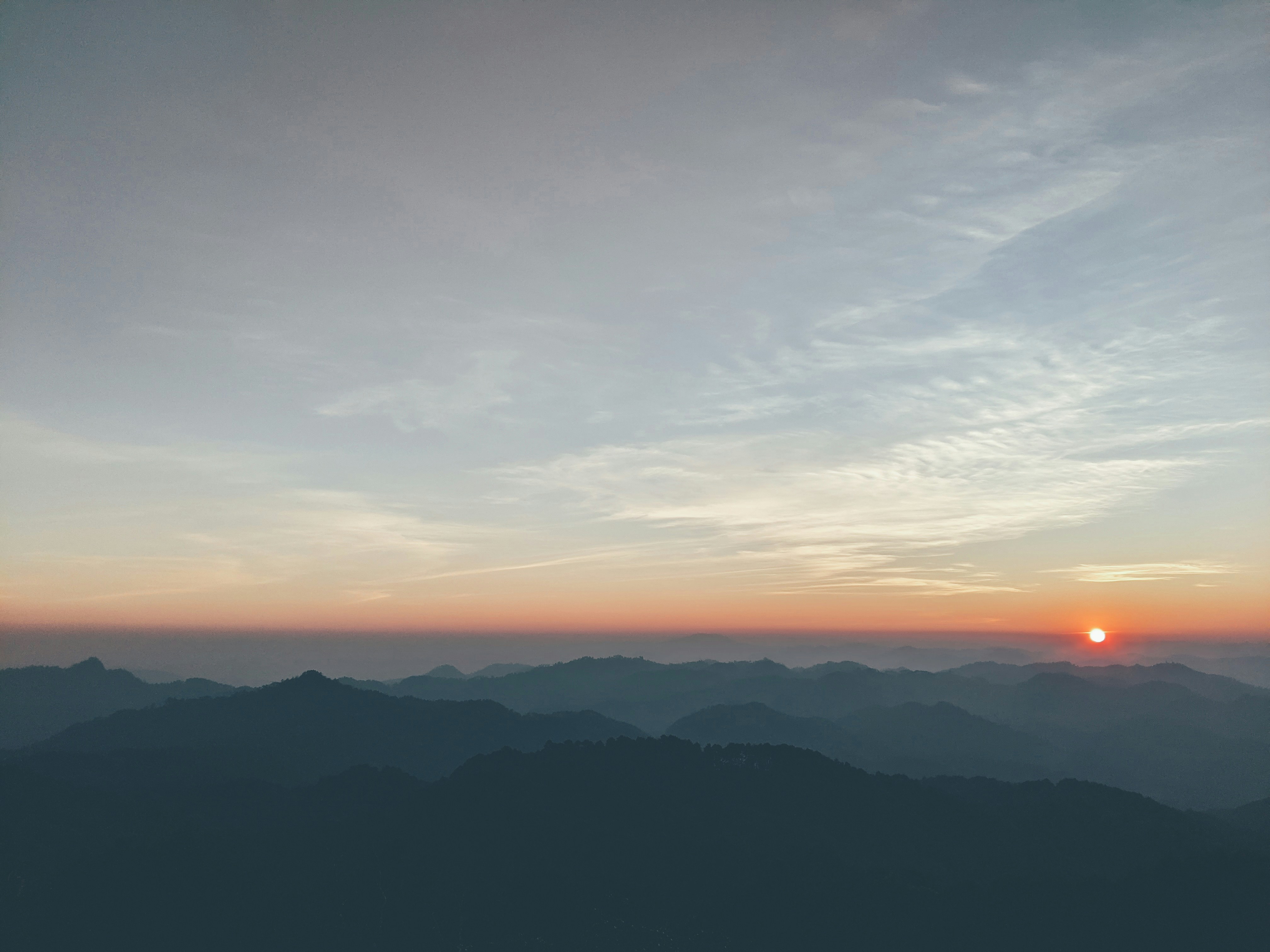 silhouette of mountain under blue sky during daytime