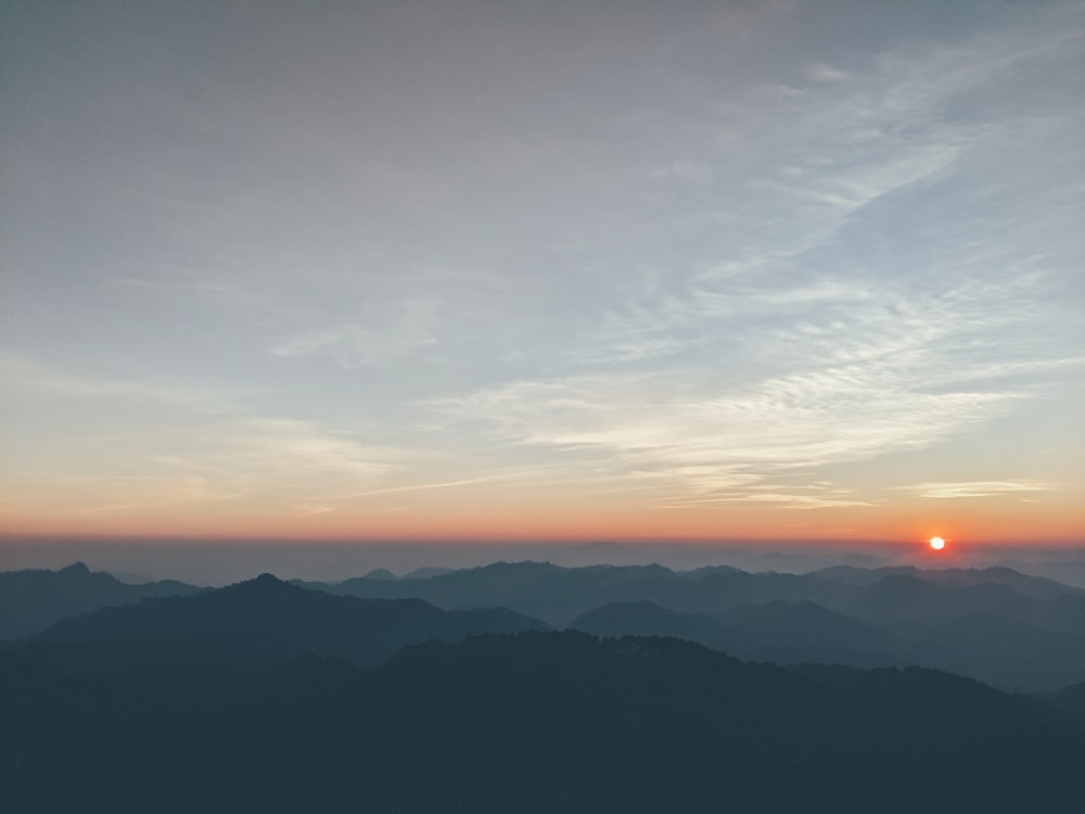 silhouette of mountain under blue sky during daytime