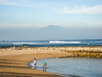 A serene family vacation scene with children playing on a beach.