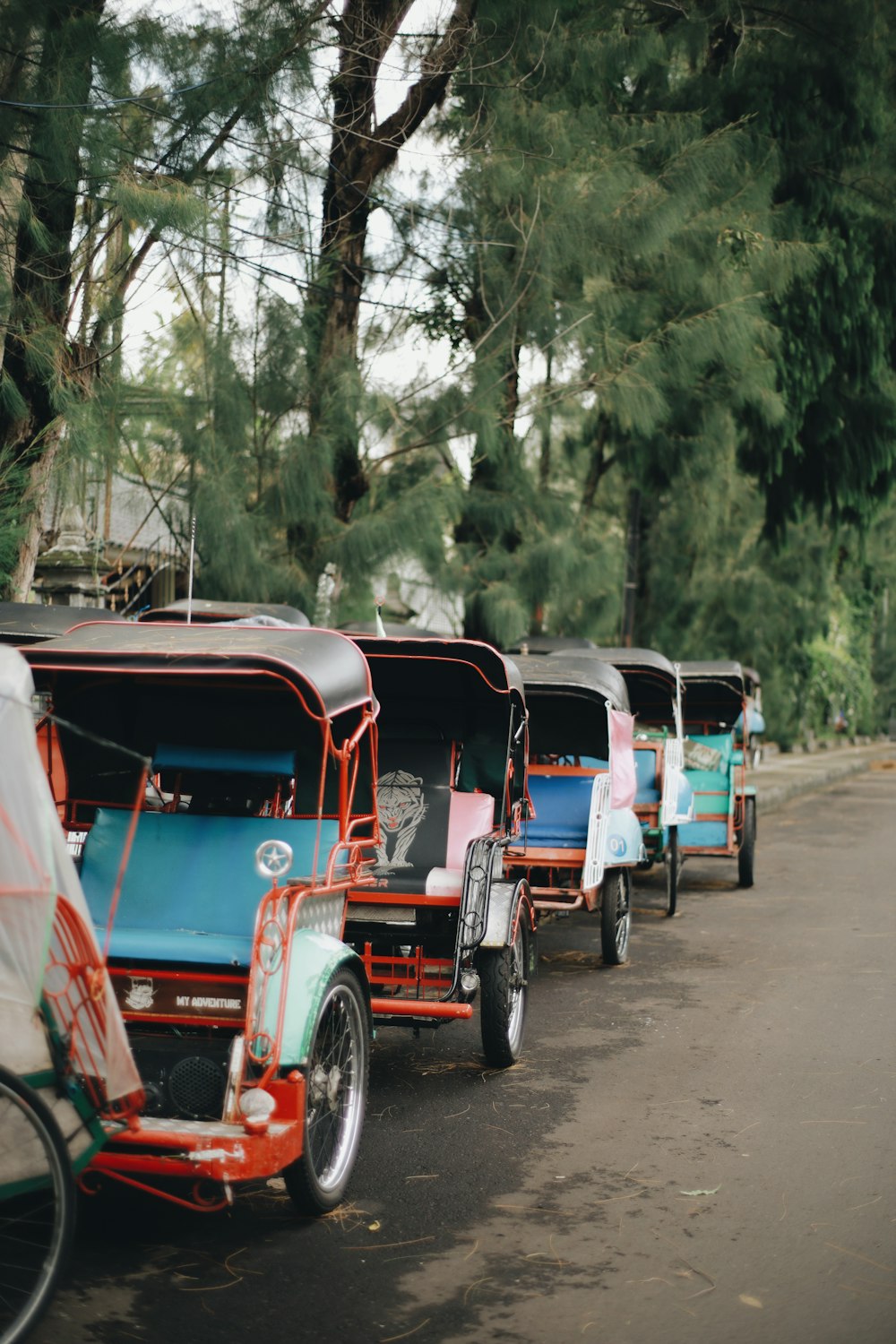 red and blue auto rickshaw on road during daytime