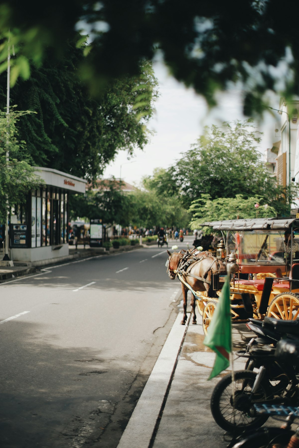 Sosrowijayan Yogyakarta — horse-drawn andong carriage on city street near the train station area