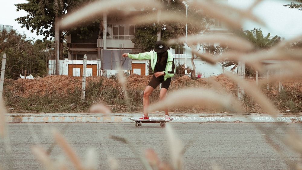 man in black and green shorts playing with water