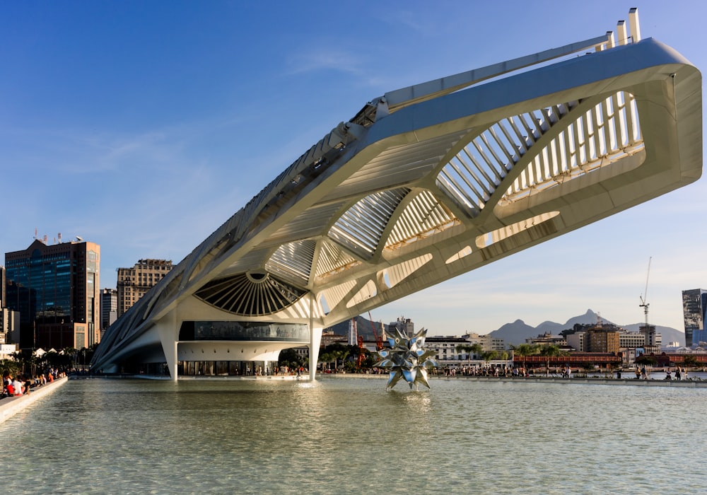 people walking on gray concrete bridge over body of water during daytime