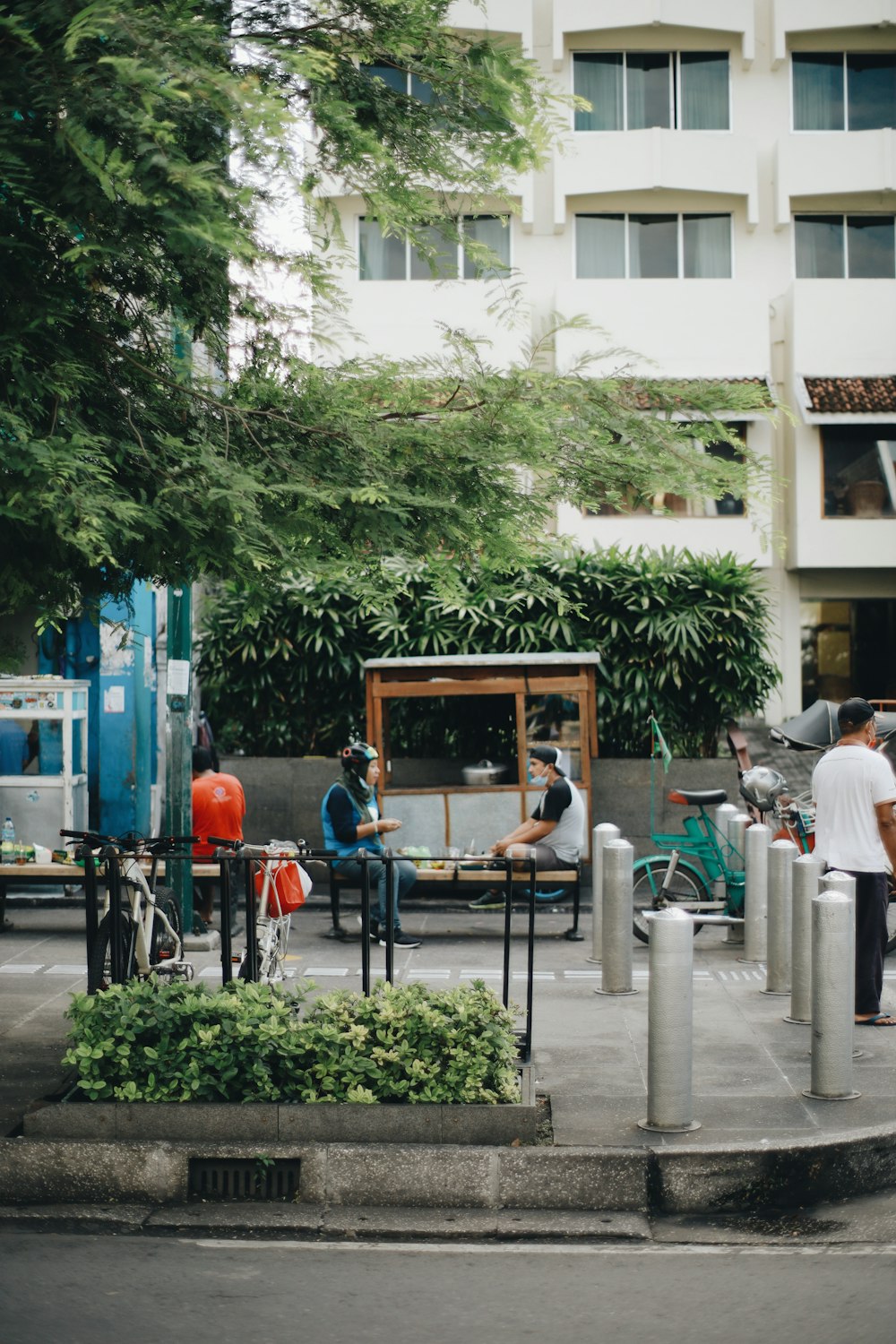 people sitting on bench near building during daytime