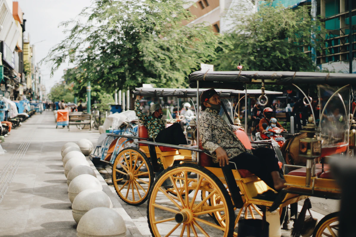People riding a wooden carriage in Yogyakarta