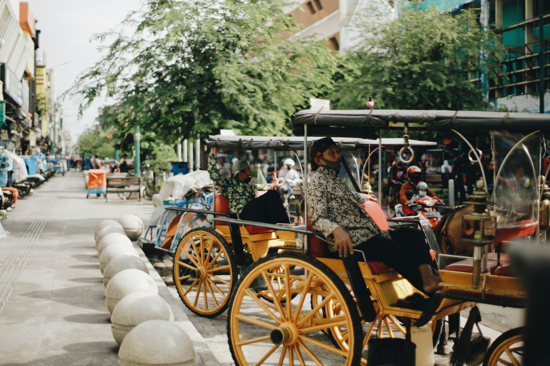 people riding on brown wooden carriage during daytime