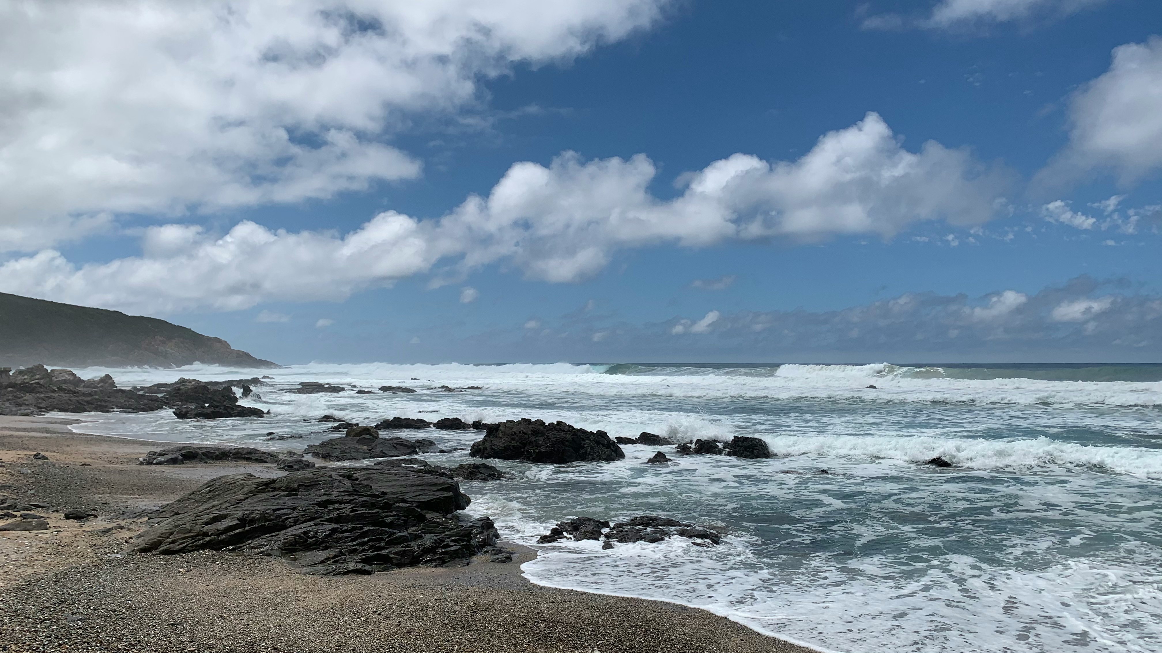 ocean waves crashing on shore during daytime