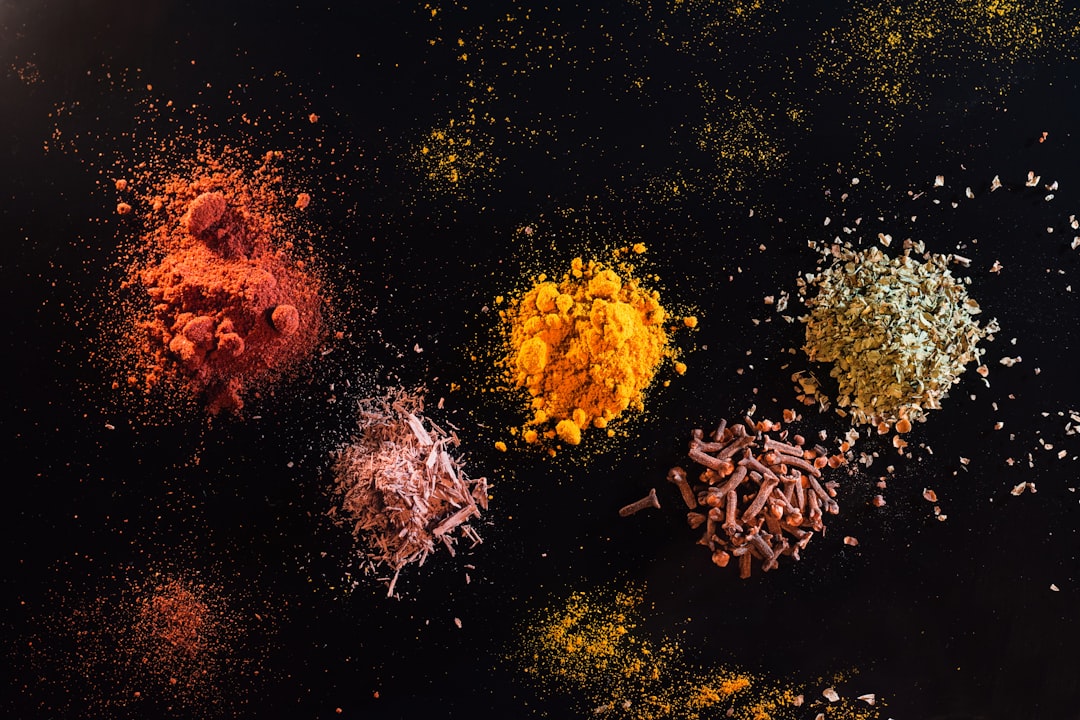 Different, colorful spices on a black backdrop