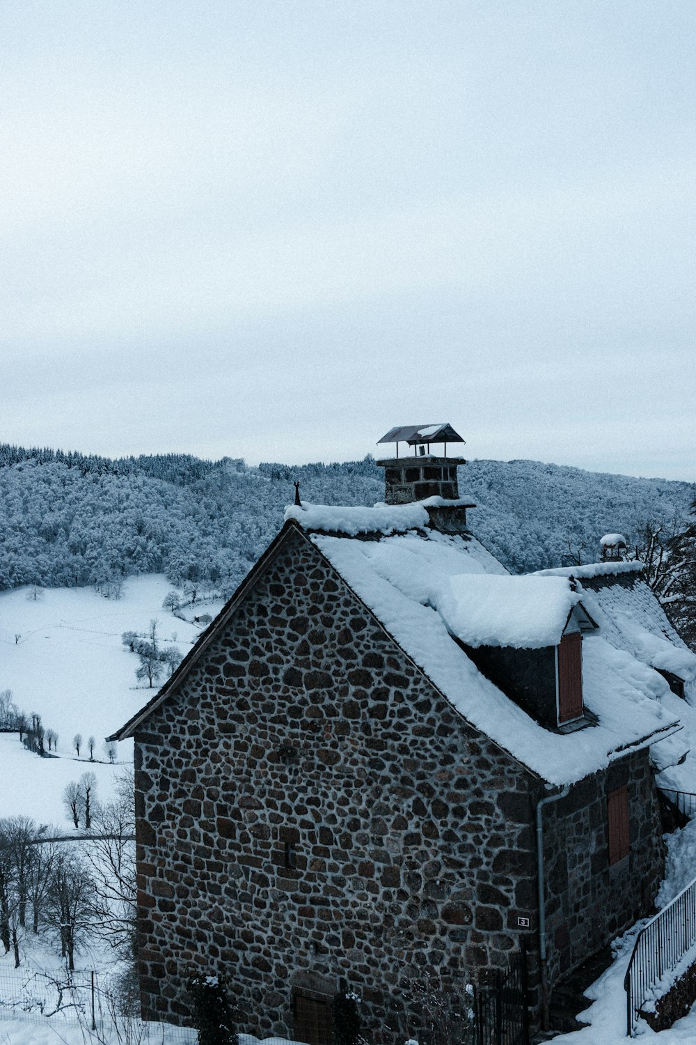 brown wooden house covered with snow