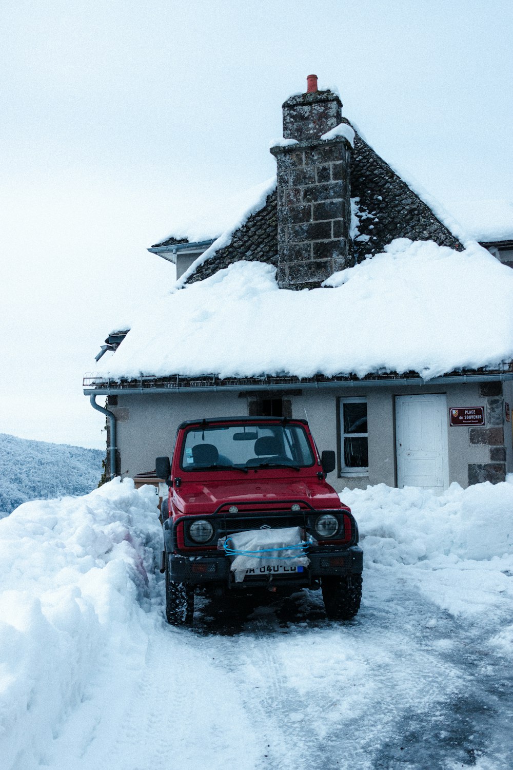 red jeep wrangler on snow covered ground near white wooden house during  daytime photo – Free France Image on Unsplash