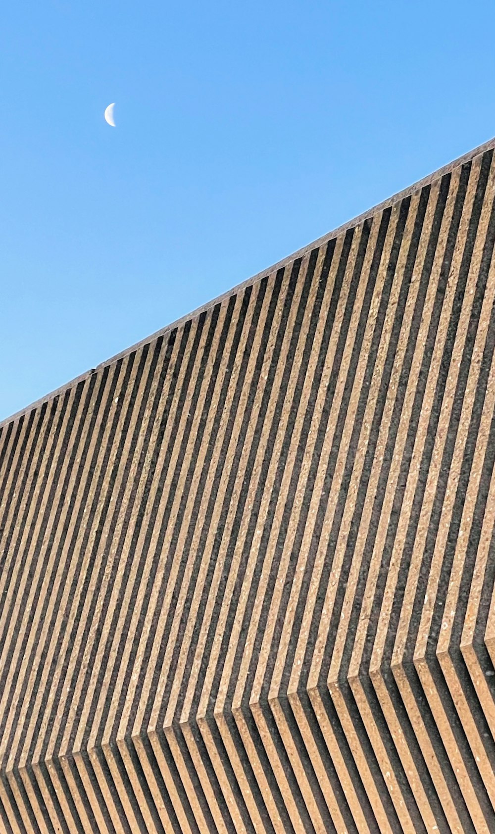 brown and black concrete building under blue sky during daytime