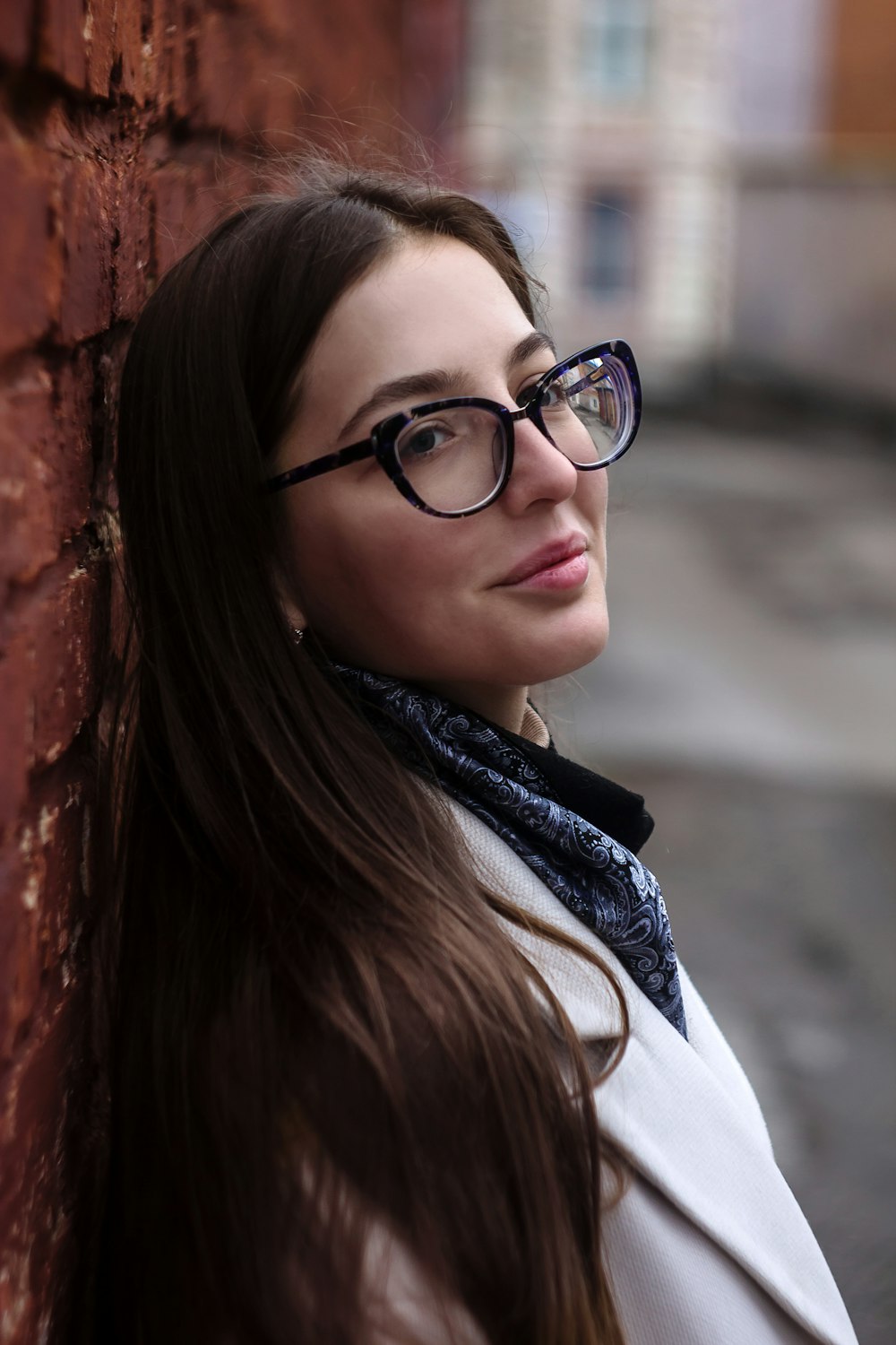 woman in black framed eyeglasses and white coat