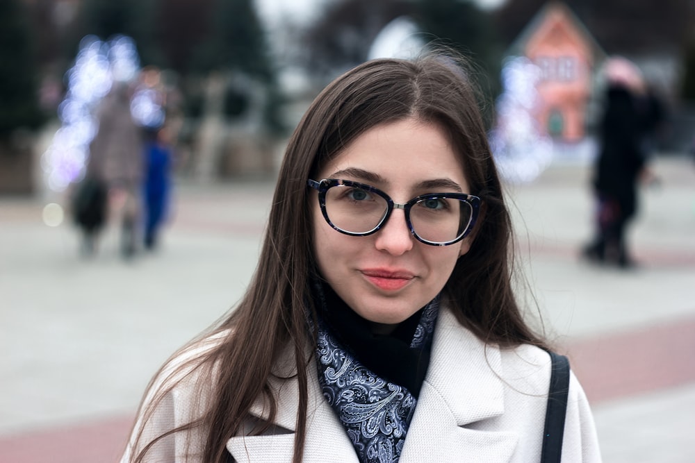 woman in brown coat wearing black framed eyeglasses