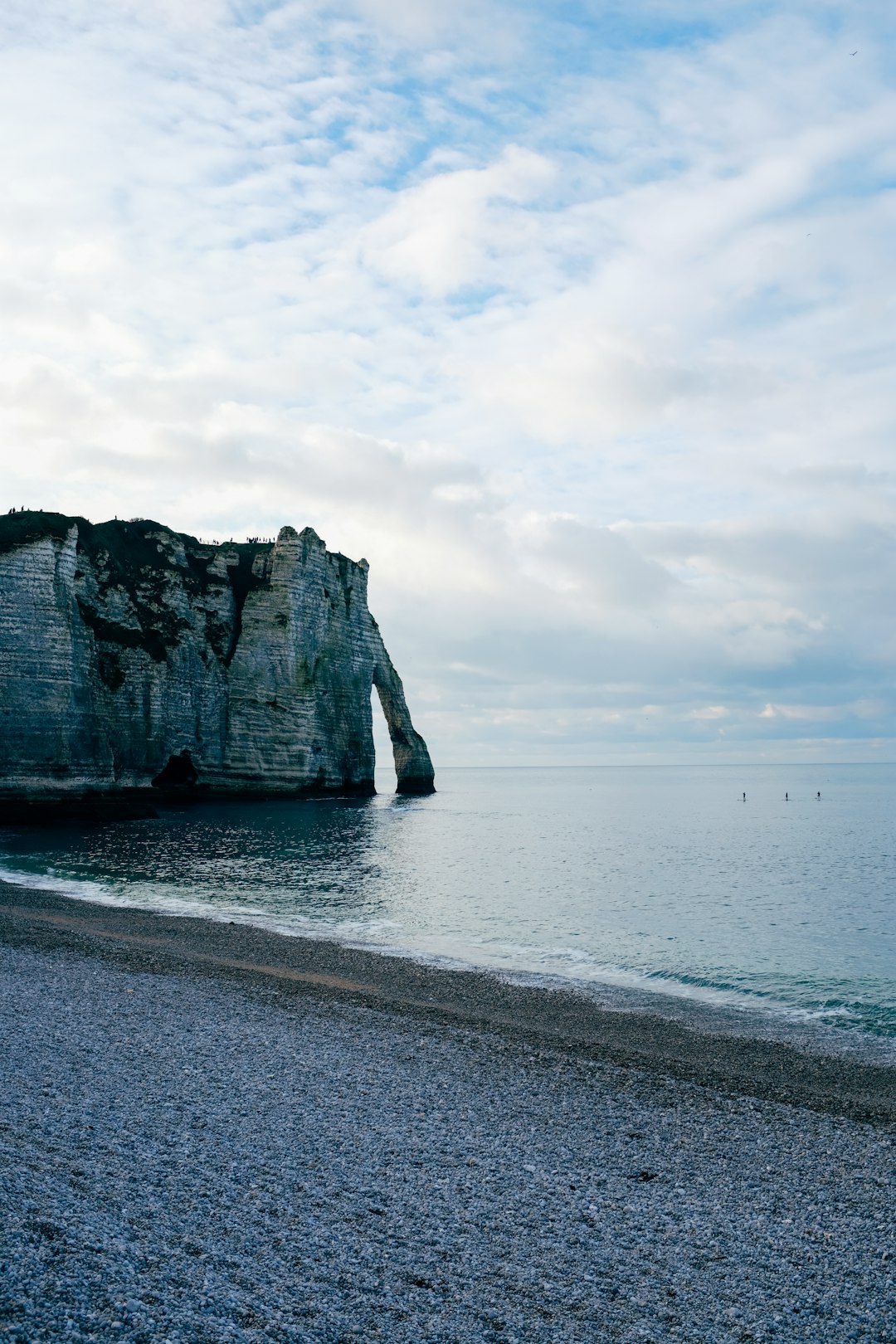 gray rock formation on sea shore under white clouds during daytime