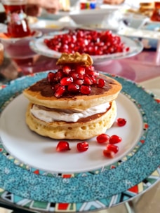 pancake with strawberry on white ceramic plate