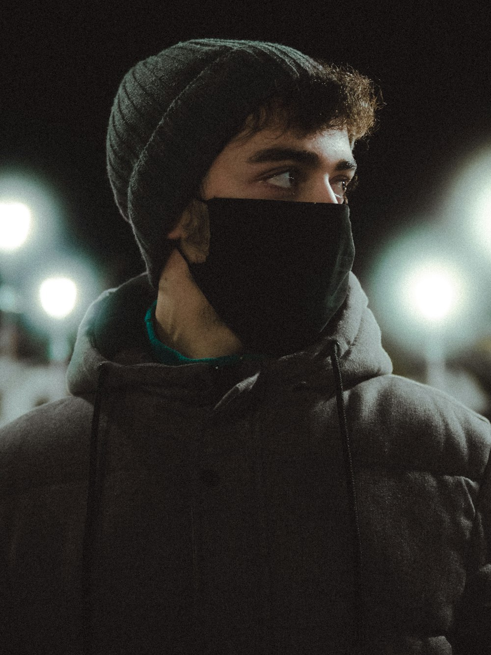 man in black hoodie wearing black knit cap