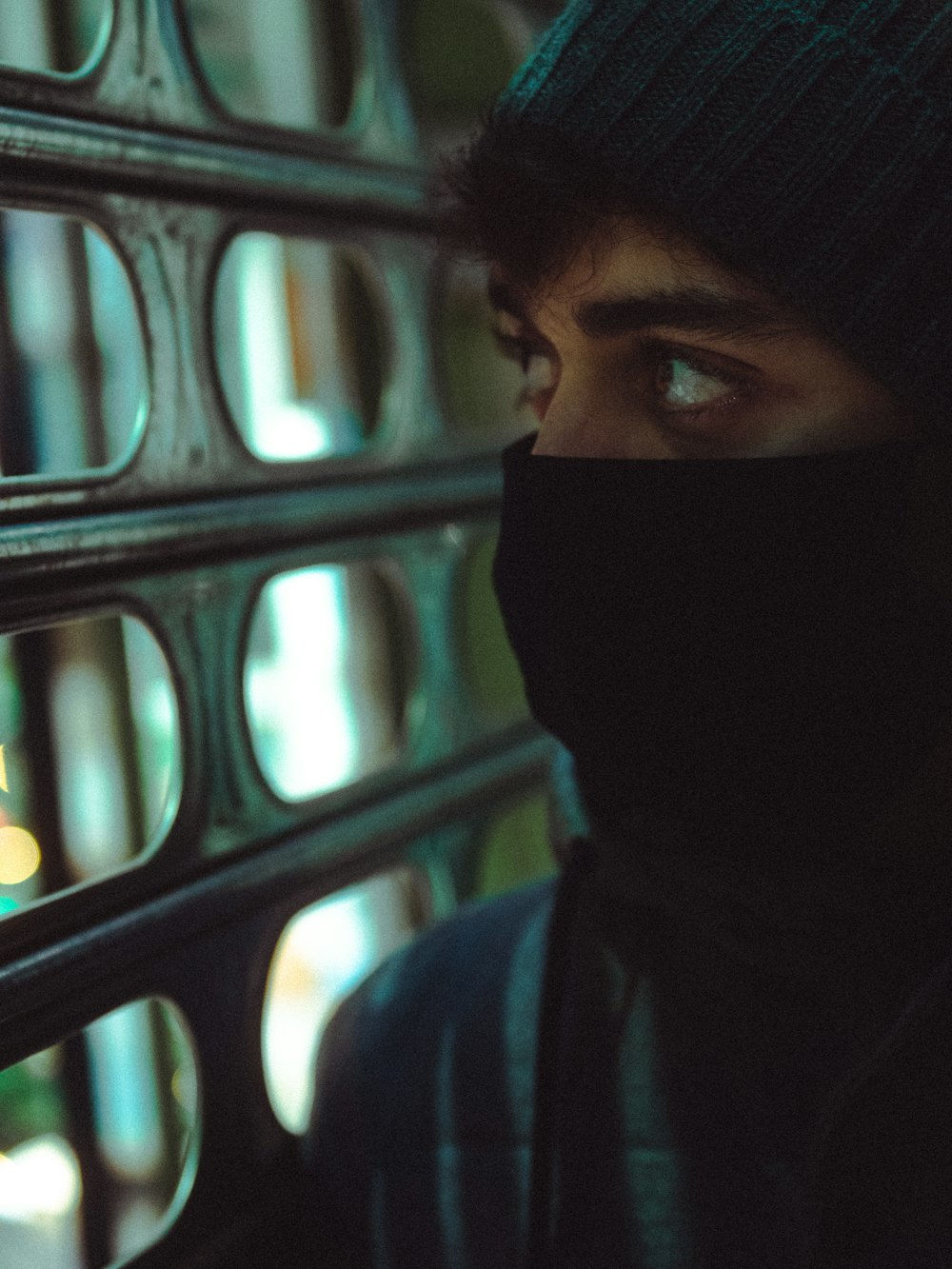 person in black hijab near black metal fence