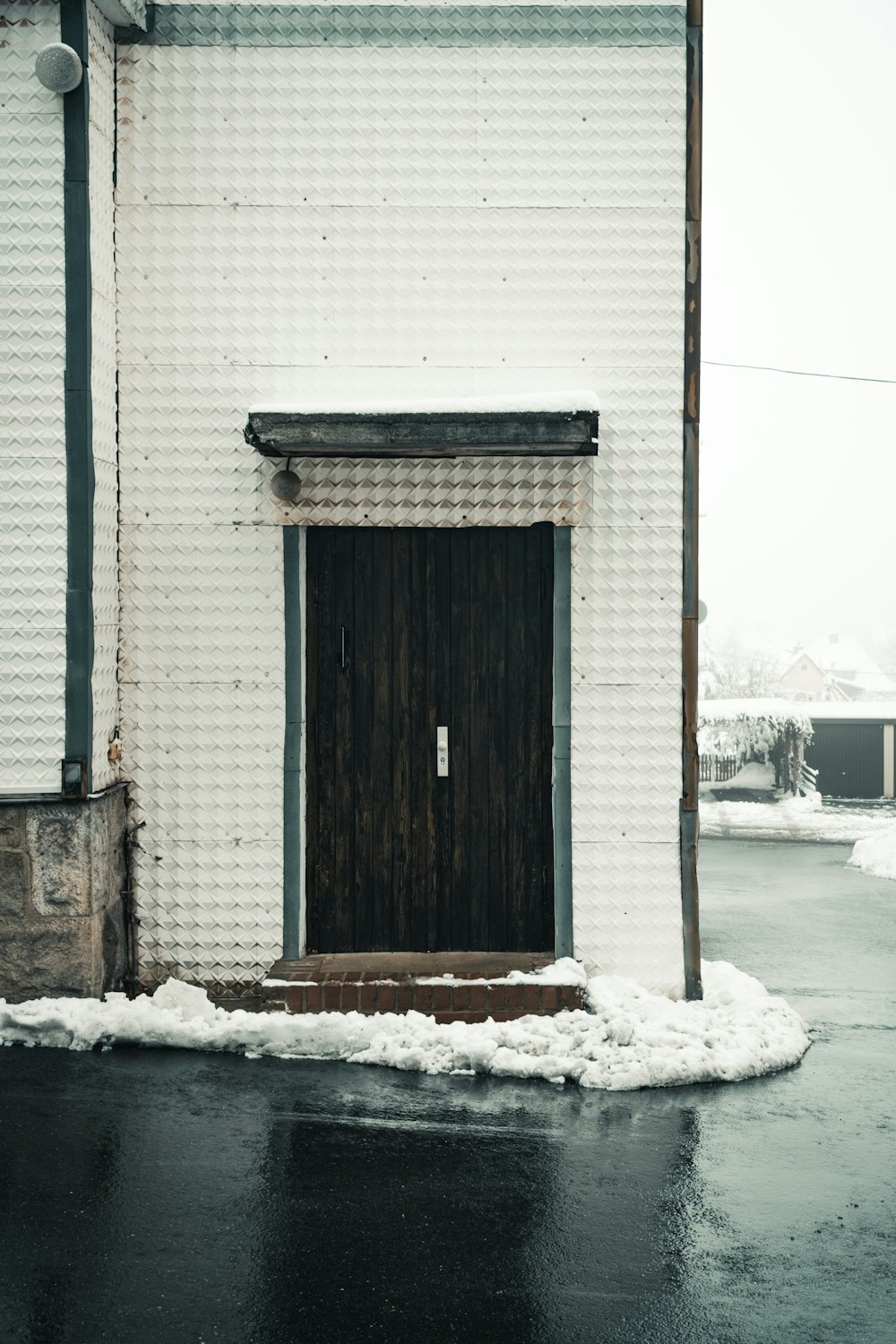 brown wooden door on white concrete building during daytime