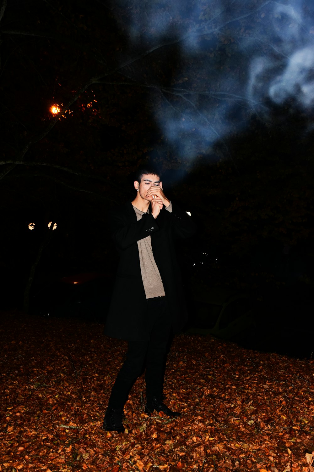 man in black coat standing on ground