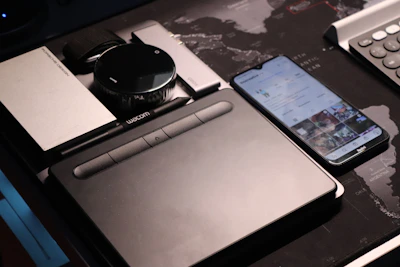 A variety of tech gadgets displayed on a sleek desk with soft lighting.