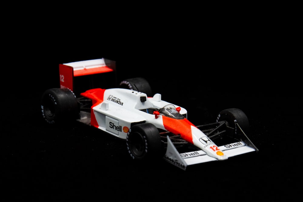 white and orange f 1 car toy