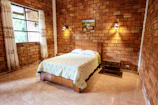 Comfortable bedroom with a mix of original stone walls and modern decor.