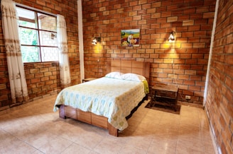 A cozy bedroom featuring hebel brick walls.