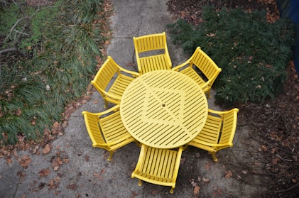 yellow wooden bench on green grass