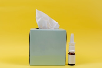 white and brown bottle beside white tissue box