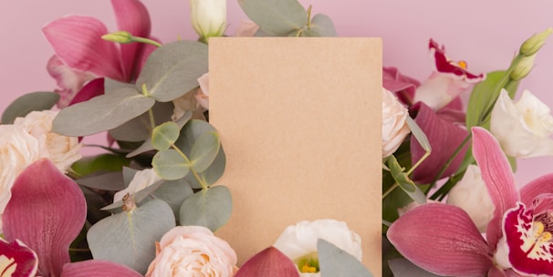 pink and white roses beside pink and white card