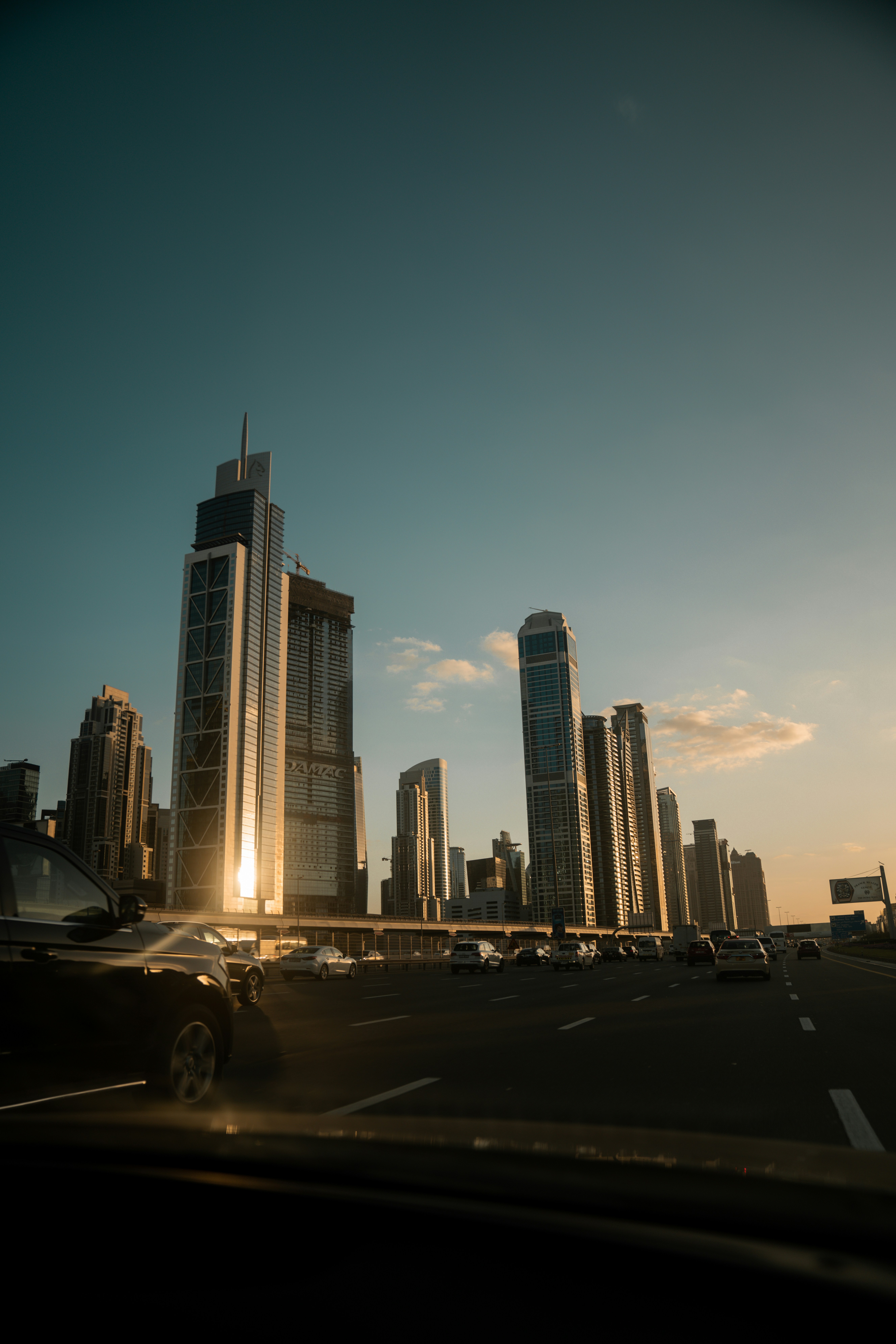 cars on road near high rise buildings during daytime
