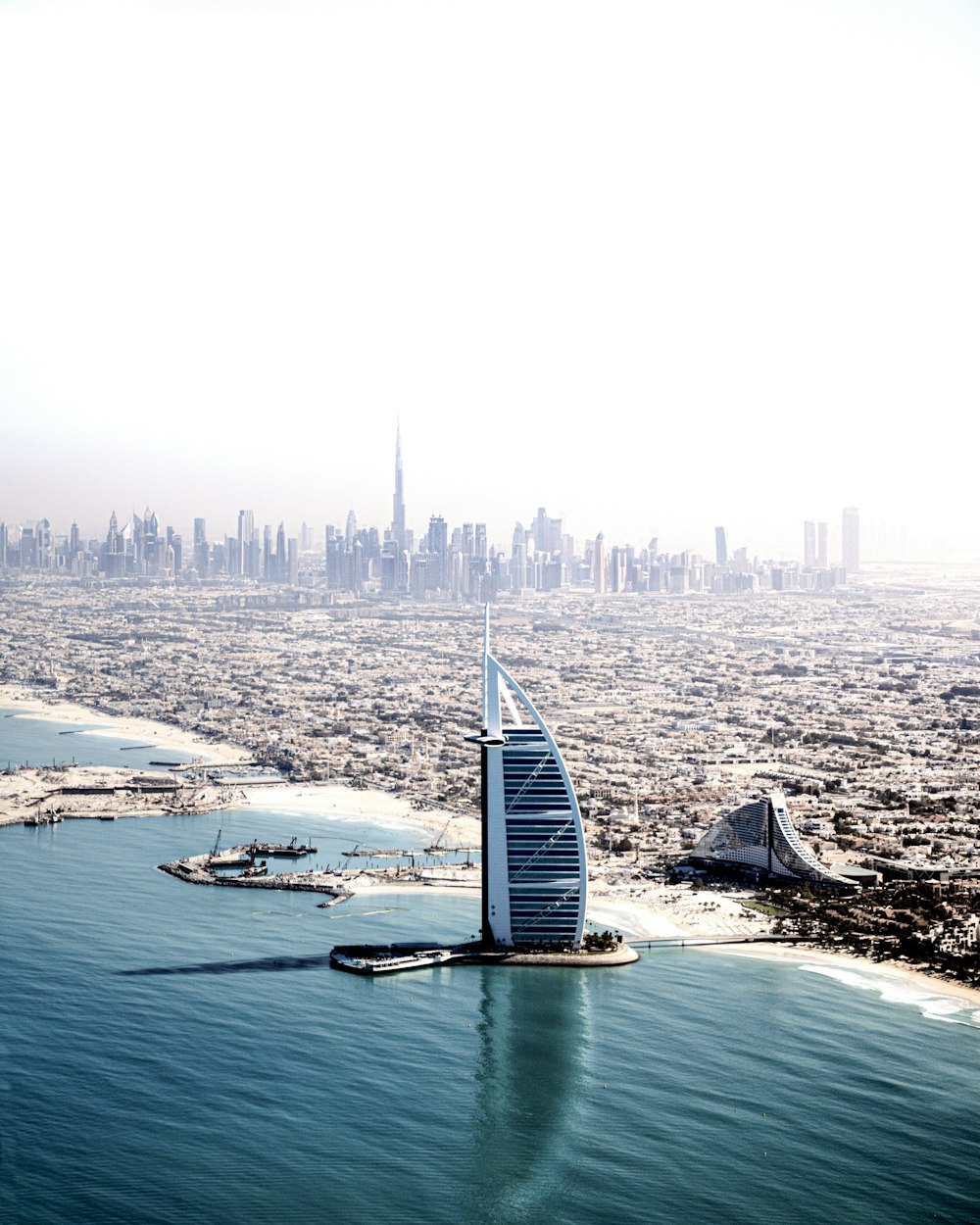 an aerial view of the burj in the middle of the ocean