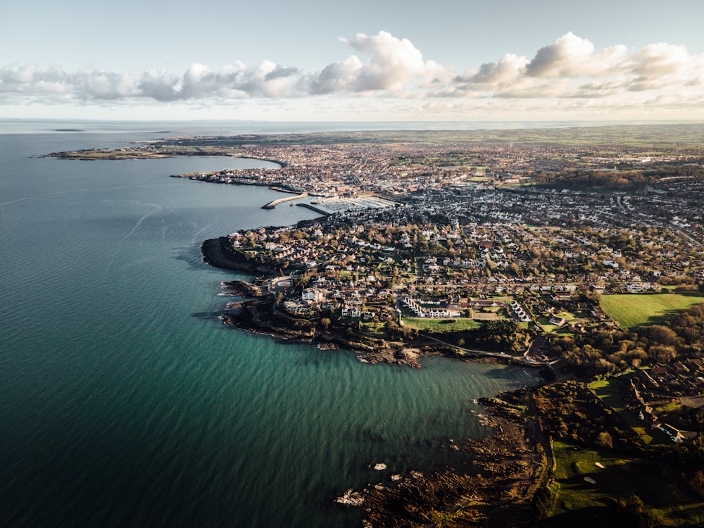 aerial view of city near body of water during daytime