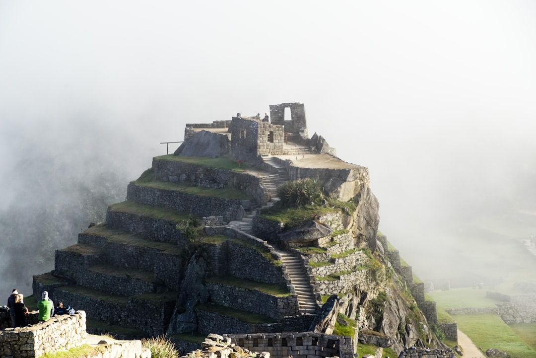 gray concrete building on top of mountain,