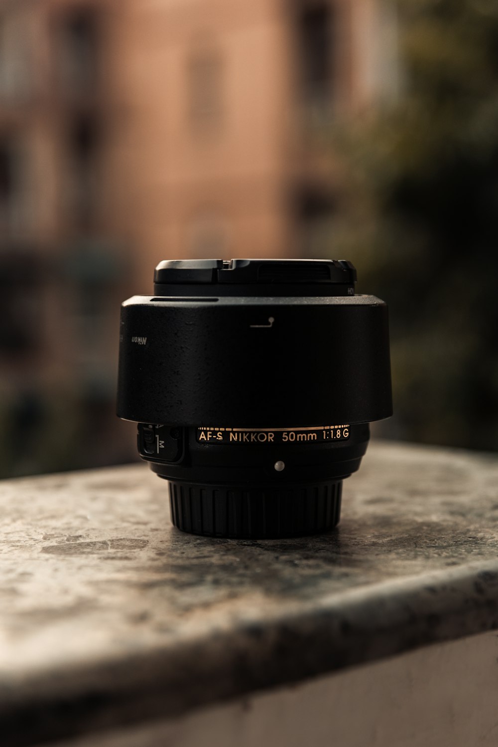 black camera lens on brown concrete floor