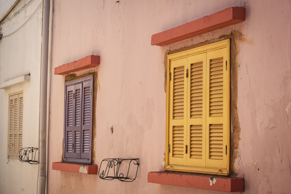 yellow wooden window frame on white concrete wall