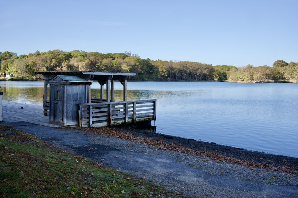 brown wooden house on lake dock during daytime