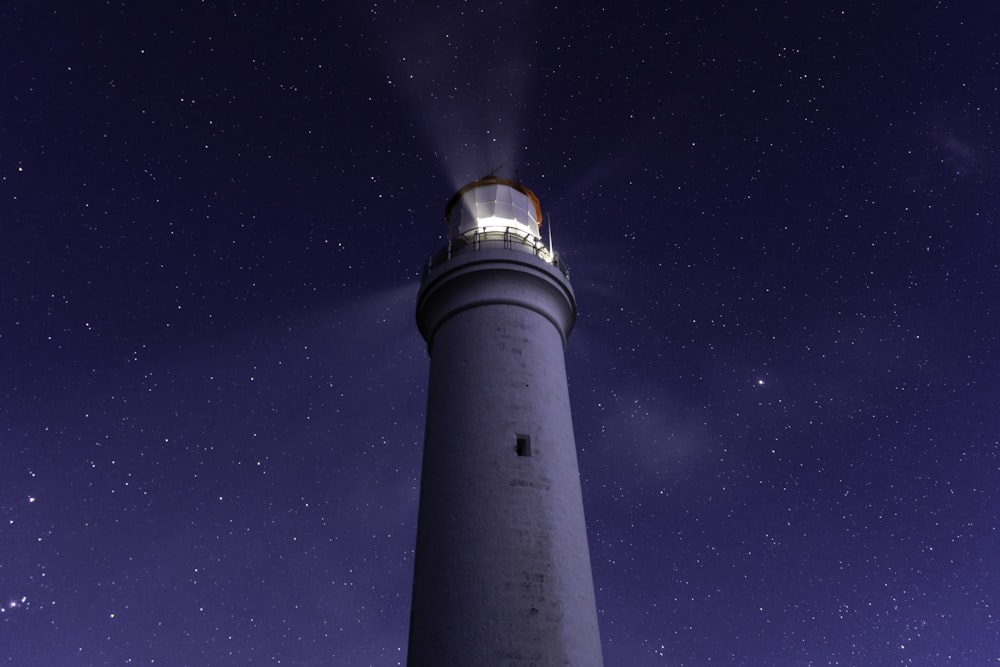 white light tower under blue sky during night time