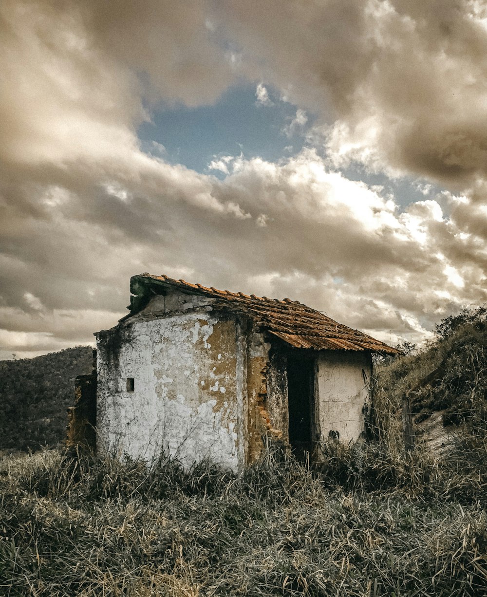 brown and white concrete house under cloudy sky during daytime